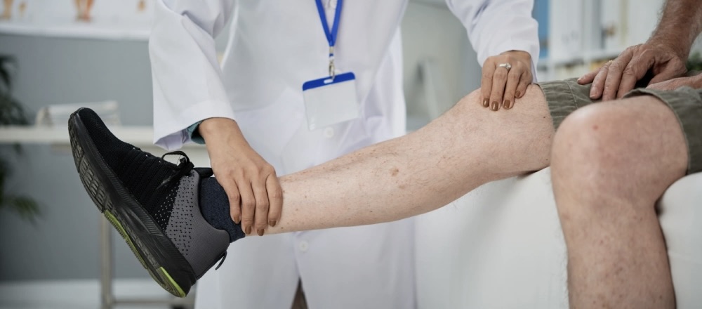 Doctor examining patient leg circulation