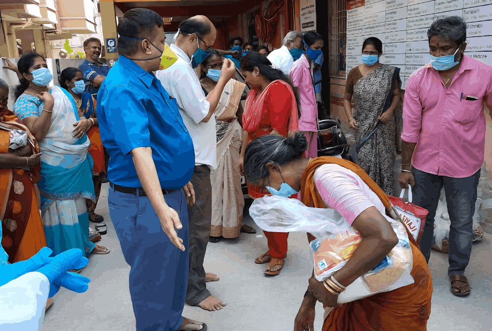 Hospital staff interacting with local citizens during a community support and distribution drive.
